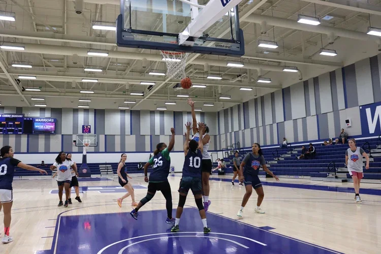 Basketball player taking a hook shot during league play